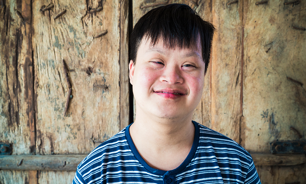 Portrait of Down syndrome boy smile with camera
